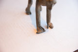 Close-up of the hand-sculpted feet and legs on the vintage monkey figurine.