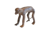Vintage handmade African monkey figurine with a textured spine and aged patina.