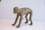 Vintage African monkey figurine showing its textured back and rustic, handmade form.