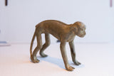Vintage African monkey figurine showing its textured back and slender profile.