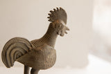 Vintage African rooster sculpture with textured neck and detailed wing pattern.