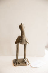 Rear view of the vintage African bird sculpture highlighting its handmade textured surface.