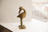 Side profile of the vintage African bird sculpture, showing its handmade texture and unique form.