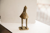 Vintage African bird sculpture with textured body and backwards-facing head on a flat base.
