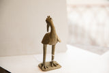 Back view of the African bird sculpture highlighting its aged, textured surface.