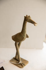 Vintage African bird with fish sculpture seen from the side, highlighting its aged patina.