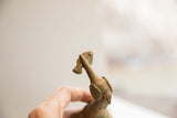 Aged surface texture and handmade details on the bird with fish sculpture's head.