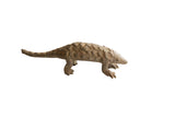 Vintage handmade African pangolin sculpture with textured scales and an earthy brown finish.