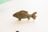 Side profile of a handmade African fish figurine with a rustic, patinated finish.
