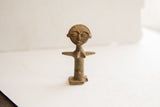 Vintage tribal woman figurine with a rustic, handmade texture and weathered patina.