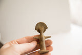 Rear view of the African woman figurine highlighting its rustic handmade texture.