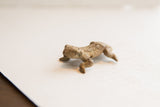 Profile view of the vintage African frog showing its handmade textured body.