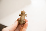 Overhead view of the handmade African frog figurine highlighting its rustic texture.