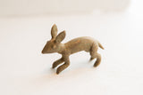 Vintage African rabbit figurine in profile, showing its rustic form and aged patina.