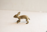 Profile view of the vintage African rabbit figurine highlighting its handmade shape.