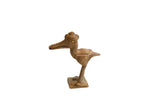 Vintage African crowned bird figurine with a rustic, handmade texture and aged patina.