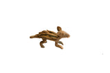 Vintage African porcupine eating figurine with a textured, lightly oxidized finish.
