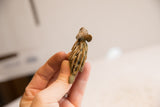 Vintage African porcupine figurine held in hand to show scale and textured quills from above.