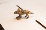 Side view of the vintage African porcupine figurine highlighting its rustic handmade texture.