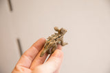 Angled view of a vintage porcupine figurine detailing its sculpted quills and rustic texture.