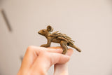 Small vintage African porcupine figurine with textured quills held in hand for scale.
