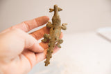 Vintage African crocodile figurine held in hand, showing its size and detailed back texture.