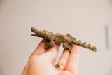 Side view of the handmade vintage African crocodile highlighting its textured, imperfect body.