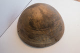 Close-up of antique African Nupe wooden bowl with incised patterns and aged surface cracks.