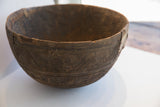 Visible old repairs and incised geometric patterns on the side of the antique Nupe bowl.