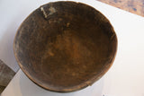 Dark, hand-carved interior of the antique African bowl, showing aged wood grain.