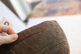 Aged dark wood rim of Nupe bowl showing incised geometric patterns and vintage patina.