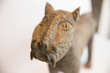 Aged metallic texture on the vintage African leopard casting's face with sharp fangs.