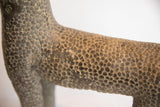 Close-up of collectible African leopard casting with a rough, spotted texture.