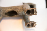 Hollow bronze back legs of the vintage African leopard casting, showing textured paws.