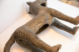 Detailed view of the vintage African leopard casting, showing its pitted texture and hollow torso.