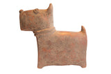 A vintage African terrier dog sculpture with a handmade, blocky form and a weathered reddish-brown patina.