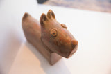 Rustic handmade details on the face of the vintage African terrier sculpture.