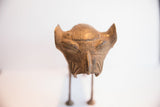 Detailed view of the hand-carved face on the vintage African lion dog sculpture.
