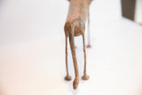 Rear view of the vintage African lion dog sculpture, highlighting its long tail.
