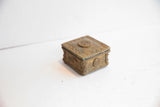 Aged patina and circular side motifs on a vintage handmade African box.