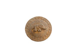 Vintage African circle box lid with a raised elephant and a decorative border with a rustic, aged patina.