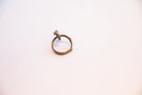 Angled view of a vintage bronze ring with a cast chameleon and a textured, patinated band.