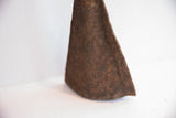Rustic brown patina and textured surface of the handmade Yoruba iron bell.