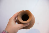 Top view into the rustic opening of a handmade antique terracotta vase.