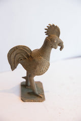 Muted bronze vintage African rooster sculpture's ringed neck and worm.