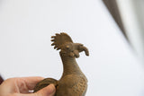 Vintage handmade African rooster sculpture, showing textured comb and ridged neck.