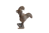 Vintage African rooster sculpture with a lightly oxidized patina and textured details.