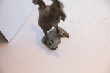 Lightly oxidized patina on the textured base and feet of the vintage rooster sculpture.