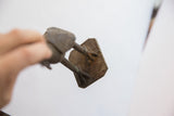 View from below showing the textured base and feet of the vintage bird casting.