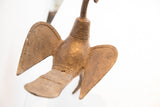 Overhead view of the cast metal bird sculpture, highlighting its incised patterns and aged patina.